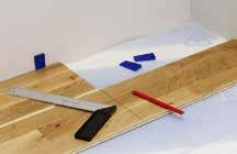 Place the tapping block against the short end of the board and tap the boards together with a hammer.