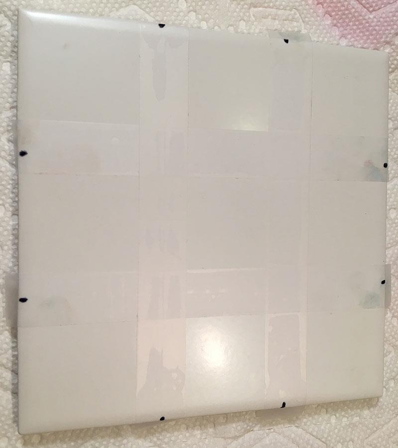 Next, cut and place the scotch tape to line up with the markings on the tile. See image.