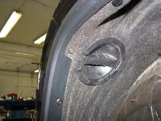 Remove the push pin from above the front tire on the top of the wheel well cover.