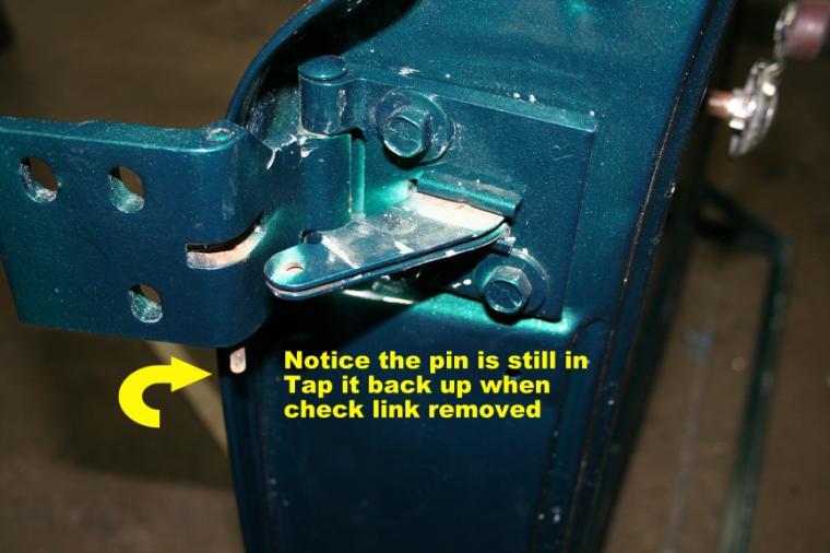 8. Take you thin center punch and hammer down the pin that holds your check link in place.