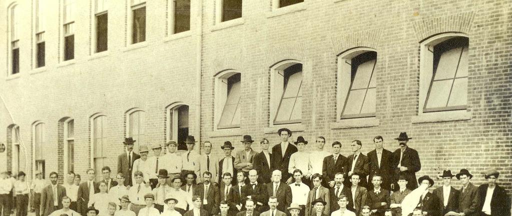 This large group of men is thought to be posed outside of the New Mill, Mill No. 5.