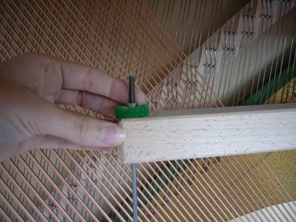 When you depress the middle pedal, the hammers hit the felt, which acts as a muffler between the hammer and strings, before hitting the strings.