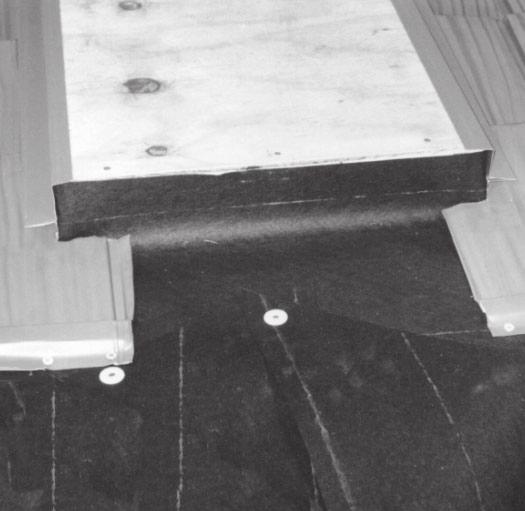 Extend the felt up the curb at the back of the skylight. Be sure to place the underlayment under the course of underlayment above it.