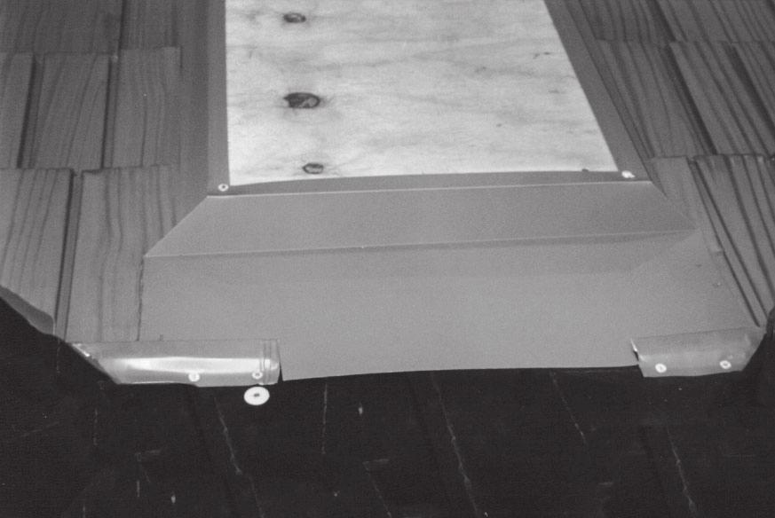 The back flashing must be formed to extend up the roof approximately 12" behind the skylight. This flashing should cover the skylight curb and should be extended 3" past both sides of the skylight.