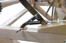 To advance the cloth, pivot the front lever to the back of the loom in order to release the