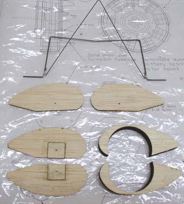 Find the balsa parts for the wheel pants and laminate them together. Be sure to make a left and right side. Insert the plywood plate on the inside cover.