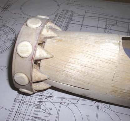 Carve and sand the bottom rear portion of the cylinder fairing to fit the fuselage and round off the top areas.