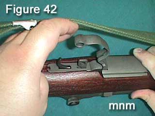 aligning lugs in the trigger assembly in the channels in the receiver.