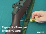 Use the slotted screwdriver to pull trigger housing guard to rear and then downward.