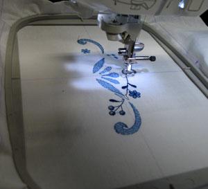 Attach the hoop to the machine, load the design, align the needle directly over the center point, and embroider the design.