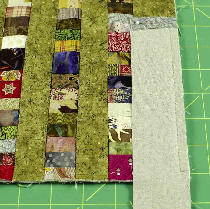 Align the raw edge of the binding strip with the raw edge of the quilted quilt top, batting and backing, right sides