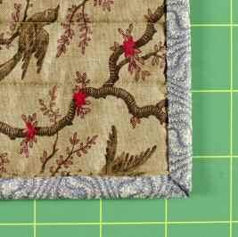Turn the binding to the quilt back.