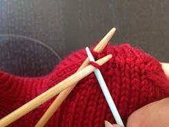 4) Insert the tapestry needle into the next stitch on the back needle knitwise, and pull the yarn  You