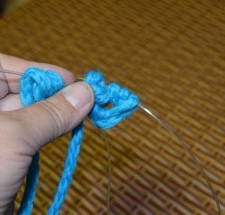 On the knitting needle, you can see 4 new stitch loops.