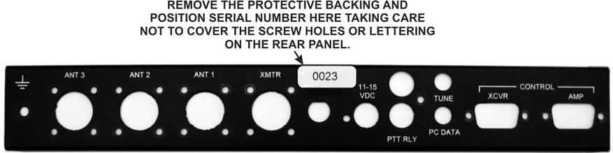 Remove the protective backing from the serial number label and press it onto the rear panel as shown