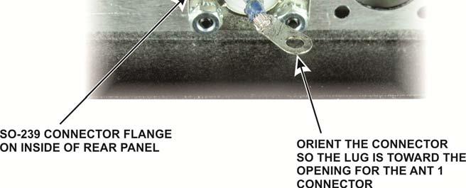 Place the flange of the connector inside the rear panel, and orient the