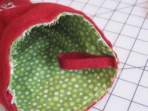 Baste the lining to the stocking ¼ from the upper edge. Loop Holder Cut a ½ x 6 strip from the leftover fabric. Fold in half to ½ x 3 and press.