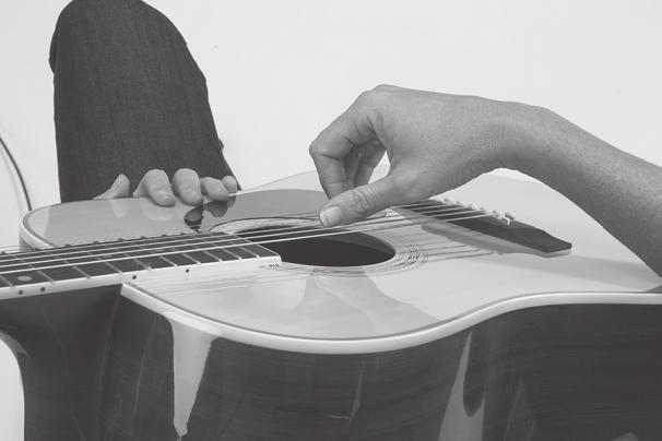 Your forearm should rest on the guitar in approximate alignment with the bridge. Arch your wrist slightly.