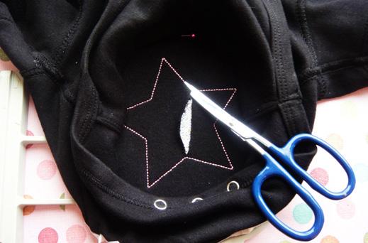 The sequin (applique) fabric will peek through. Reattach the hoop and finish the design.