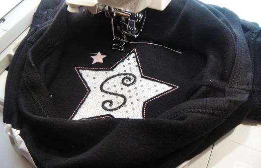 Add a cute softie (the one shown comes free with the Star Studded Applique Alphabet Set) to
