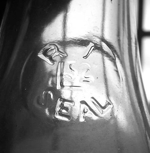 As with Atlantic Bottle (above), this was apparently a short-lived seal. R.I. L52 SEAL The Lamb Glass Co. embossed R.I. (arch) / L52 / SEAL (inverted arch) on the shoulders of its milk bottles for use in the state of Rhode Island (Figure 4).