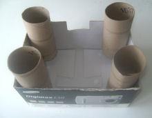 4 paper towel tubes Small box 2 colours of cardstock/paper 2 colours of paint to match paper Black pen Glue Sequins/glitter/pens to decorate 1. Cut any flaps off the box. 2. Trim the tubes to size so that they are a couple of inches taller than the box.