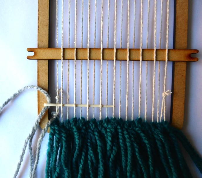 Basic weaving Place the shed stick across the loom wrap.