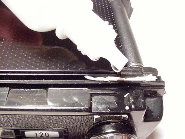 Now, let's take a look inside your camera: The first three seals we ll observe are the fabric pads (one is at each inner corner of the cradle), the hinge end seal and door edge seals (upper middle),