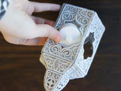 A battery-powered tea light will fit right through the opening in the lace to add a fun lighting accent