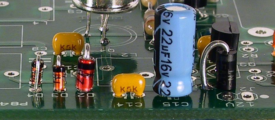 The diodes are installed with the cathode lead inserted into the hole pointed to by the arrow on the board silkscreen. Figure 4 shows the correct diode orientation. Install: 1N5817 at D1.