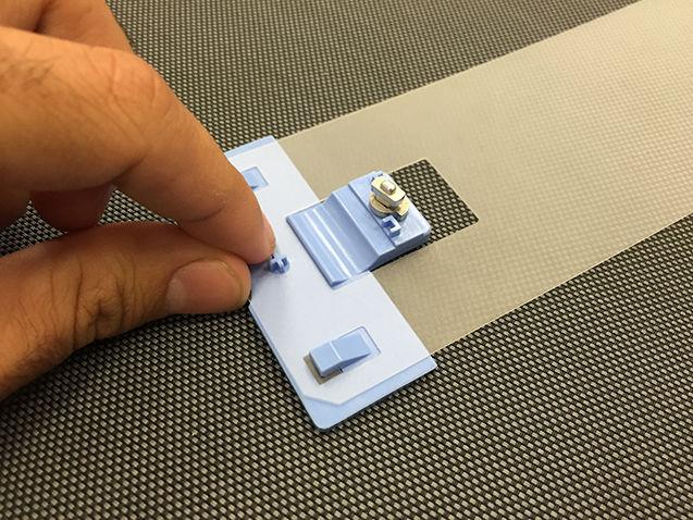 Take one of the strips provided with the kit and attach the plastic end pieces to it.