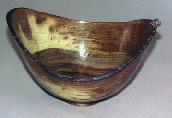 Dick Pickering presented a small walnut bowl, fairly thick, finished with