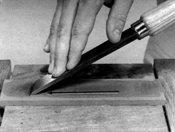 Figure 24-23. Point the cutting edge in the same direction you are sliding the skew. Figure 24-24. For narrow chisels, point the cutting edge away from the direction you are sliding the skew. edge. By repeating this procedure on progressively finer stones you will be able to hone the cutting edge razor sharp.