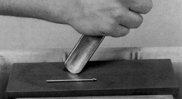 ing the gouge (Figure 24-25). Think of it as trying to shave off a thin sliver of the hone as you roll the gouge. Change to the slip. Apply a generous amount of oil to the inside of the gouge.