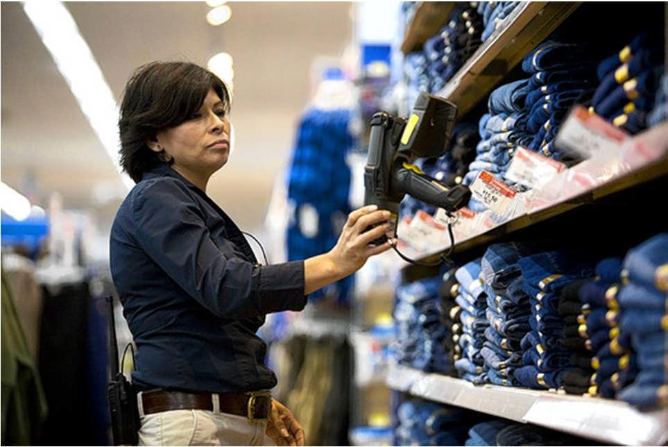 1st Movers Apparel supervisor Sonia Barrett uses a handheld scanner to read EPC labels on men's denim jeans on July 19, while checking inventory at the Walmart Supercenter Store No. 1 in Rogers, Ark.
