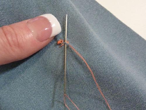 10. Bring the thread through to the back side of the fabric again. 11.