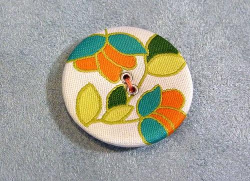 A pretty button in place with contrasting thread. 14.