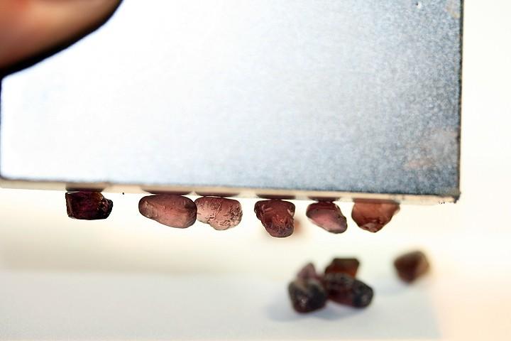 At left is a picture of a parcel of garnets with the almandite garnets being strongly magnetic to the point that a magnet