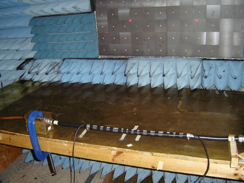 Photo 3 Cable transfer impedance test set up in anechoic chamber The current is injected via a 4mm wide braid located above and insulated from the conduit shield and returns to the signal generator
