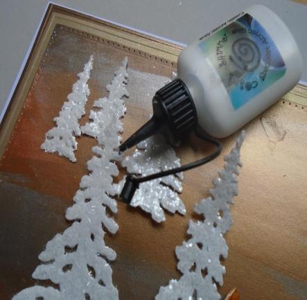 Add some Cosmic Shimmer dries clear glue behind the trees to stick them