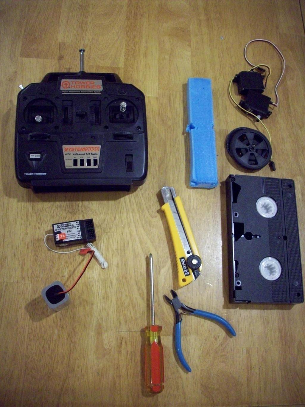 Gather Materials, Components, and Tools Radio transmitter Continuous rotation servos (two) Expanded polystyrene foam Wheels (two) Radio receiver Utility knife VHS tape Battery pack Things you don t