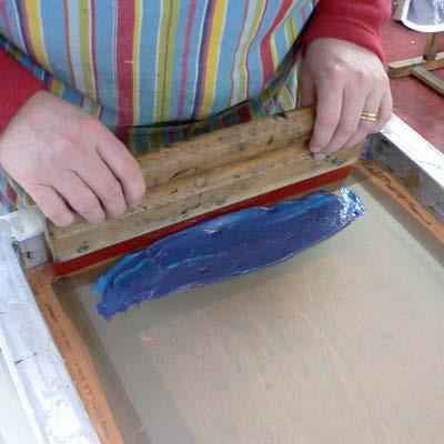 To print: 1. When the screen has been prepared and fixed into the vacuum bed or hinge board, raise the screen off the print surface by propping it up with a piece of wood. 2.