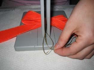 To make your first loop, fold the ribbon and press into the Bowdabra.