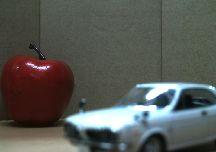 Focus on the Apple Focus on the Toy Car Processed Image with Focus Both on the Apple