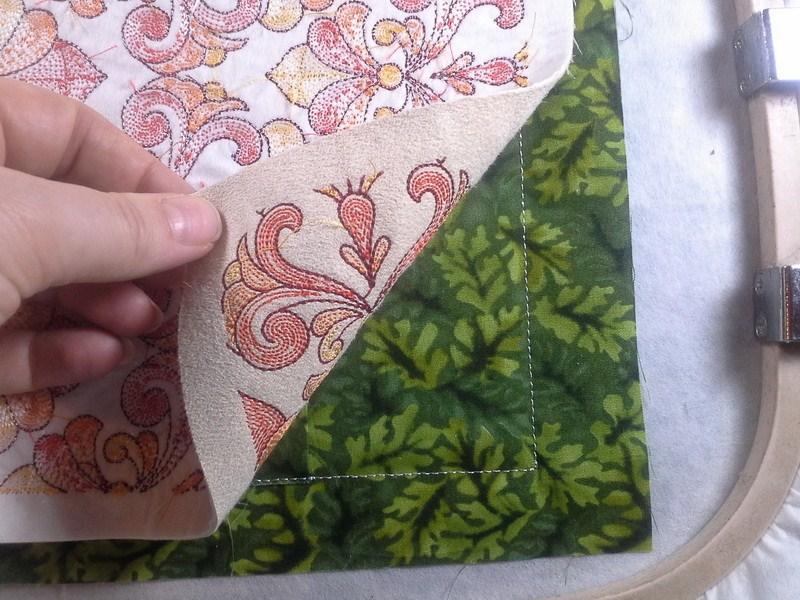 You may need to trim the fabric for the card holder where the white decorative satin stitch is. Stitch the next color.
