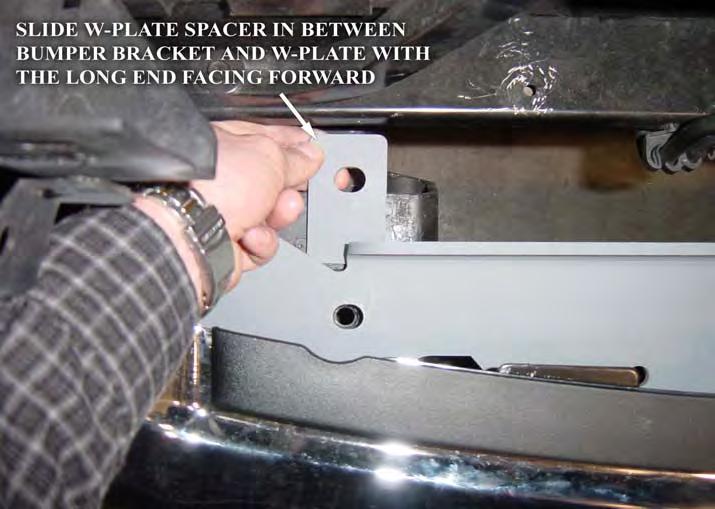 The upper tabs slide between the frame towers and the W-plate. 6. Set the W-Plate Spacers on the bumper brackets as shown in Figure 5a.
