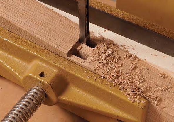This lets you cut the tenons with square shoulders. To locate the notch, dry-fit the chair and rest a straightedge on the tenon shoulder, then mark where it intersects the Notch the rear legs.