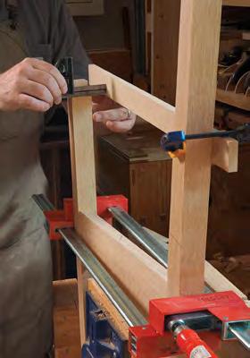 To locate the mortise side to side, clamp a straightedge to the inside face of the rear leg and measure between it and the inside cheek