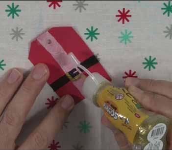 5 Step 5. Santa Gift Tag 1) Using a sheet of Red Construction Paper, cut out a tag shape with scissors. 2) Punch a hole centrally in the top of the tag.