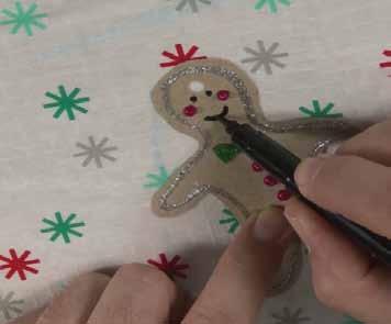 5) Using Gold Scented Glitter Glue paint in the belt buckle. 6 Step 6. Gingerbread Man Gift Tag 1) Draw the shape of the ginger bread man onto some natural card and cut around the outline.
